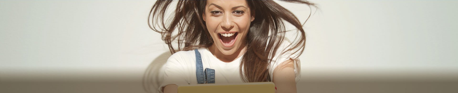 Surprised girl with tablet in its hands