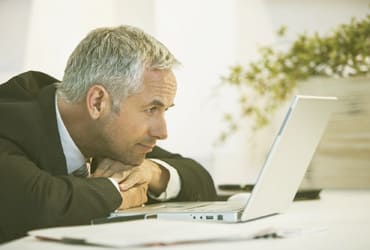 Man looking at laptop. Advantages of being our customer