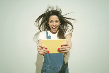 Surprised girl with tablet in its hands