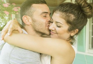 Couple kissing on the cheek