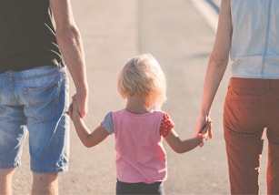 Parents catching to a girl of the hands