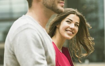 Smiling girl watching to a boy