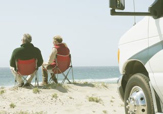 Two men sat down looking at the beach